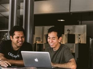 Entrepreneurs sitting together with laptop